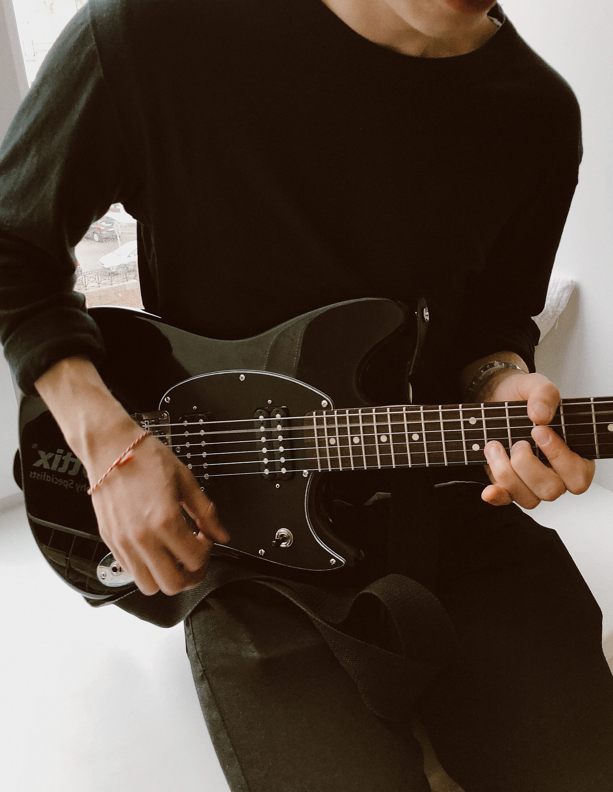 person-in-black-long-sleeve-shirt-playing-electric-guitar-3981624